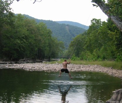 The swimming hole has a rope swing